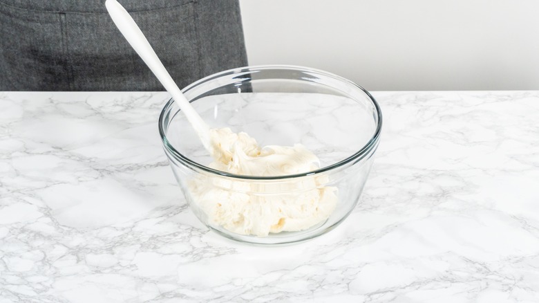 frosting in bowl with spoon