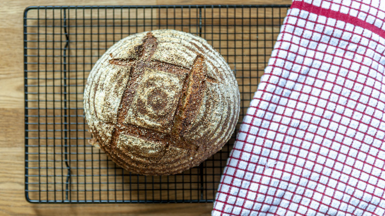 Baked bread on rack with hashtag score