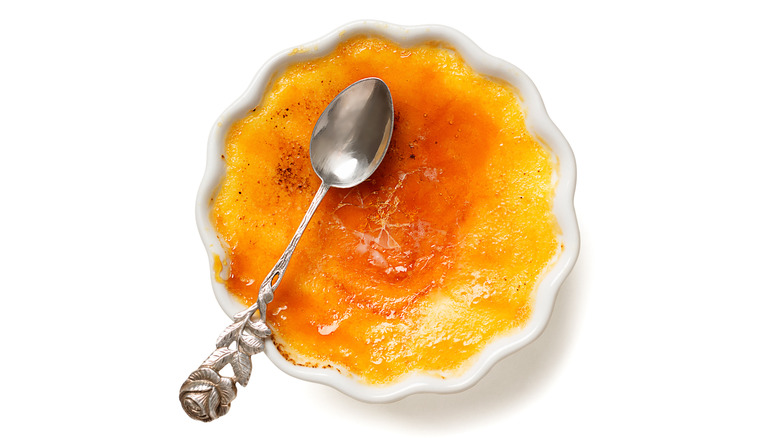 metal spoon and creme brulee