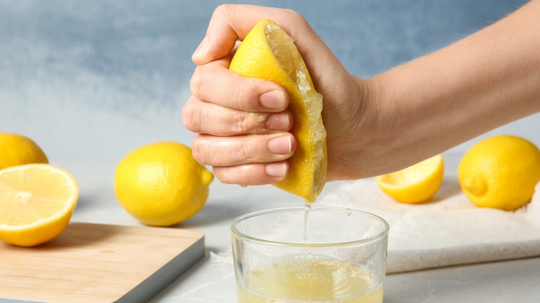 Lemons being squeezed hard