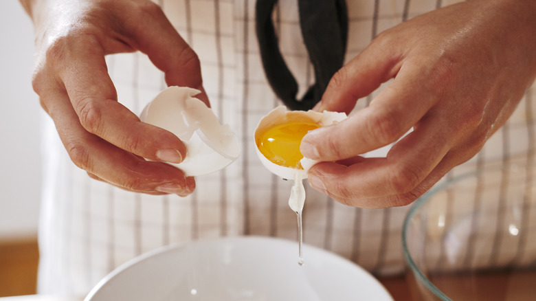 A chef separating egg whites.