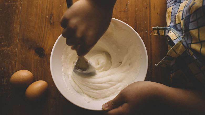 Person mixing cake mix in a bowl