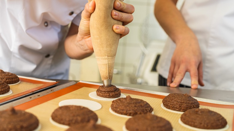 Piping bag in action on a baking sheet