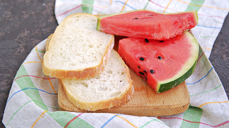 watermelon slices and bread slices on a cutting board