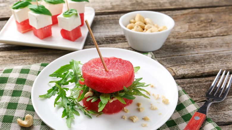 watermelon, arugula, and cashew sandwich on a plate