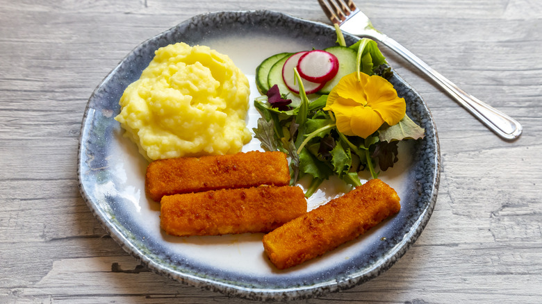 Fish sticks, salad, and potato