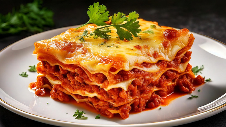 closeup of a slice of lasagna on a plate