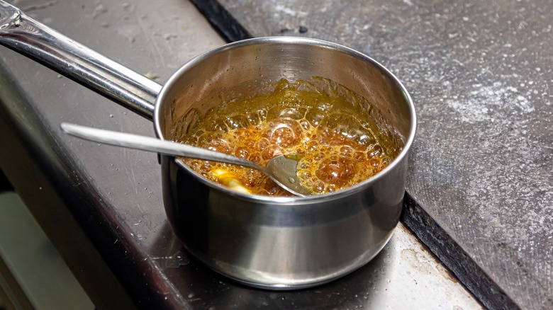 Boiling sugar syrup in saucepan