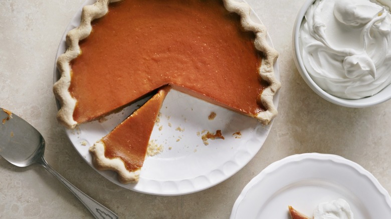 pumpkin pie with slice cut