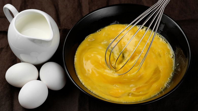 Scrambling eggs in a bowl 