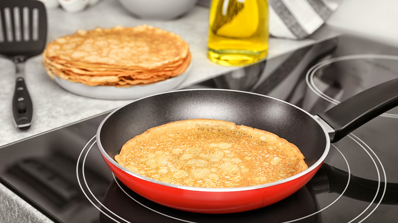 Pancake in a frying pan with oil