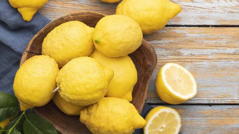 Wooden bowl of lemons