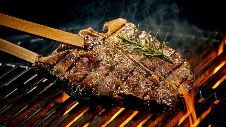 T-bone steak with thyme on the grill
