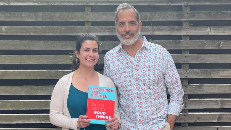 Yotam Ottolenghi and Nur Murad smiling with book