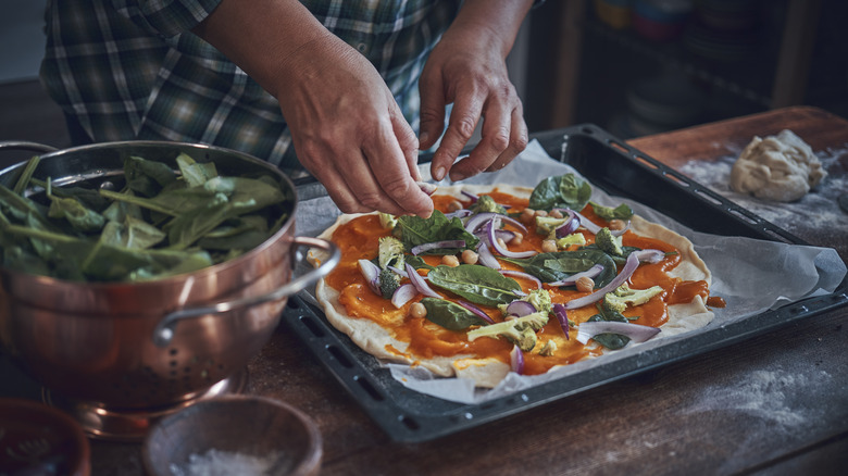 making homemade pizza on counter