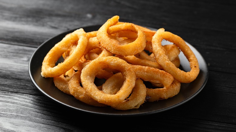 Onion rings on a black plate