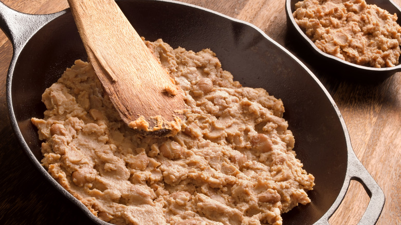 refried pinto beans in skillet