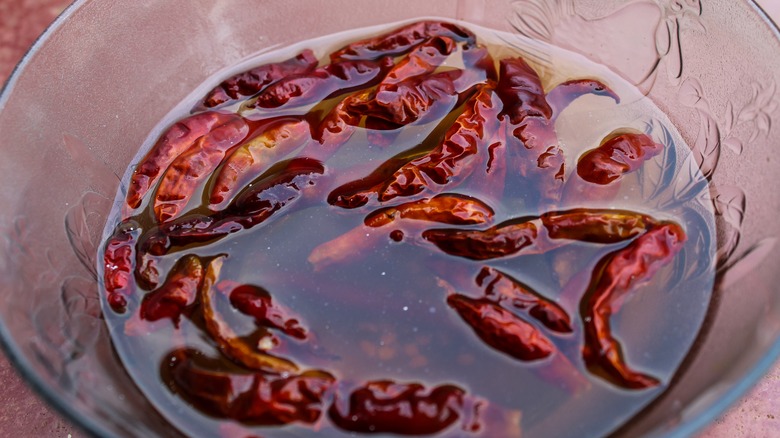 chilis soaking in glass bowl 