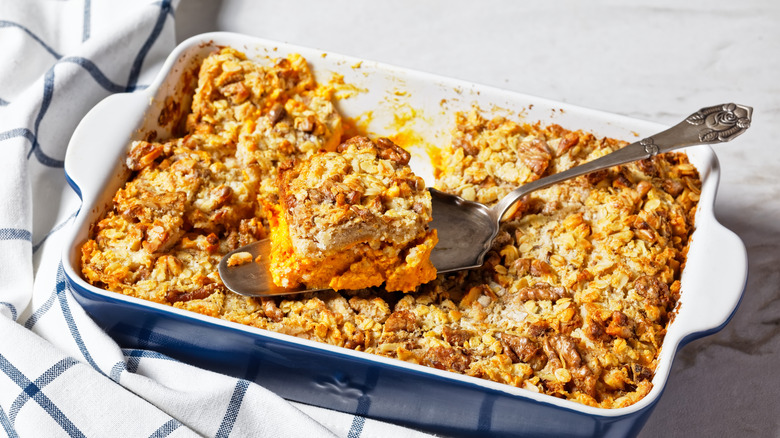 pumpkin dump cake in baking dish with spatula