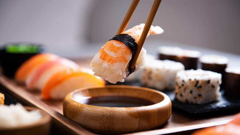 sushi dipped in soy sauce