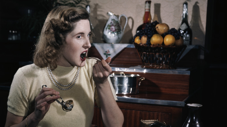 photo of woman eating escargot