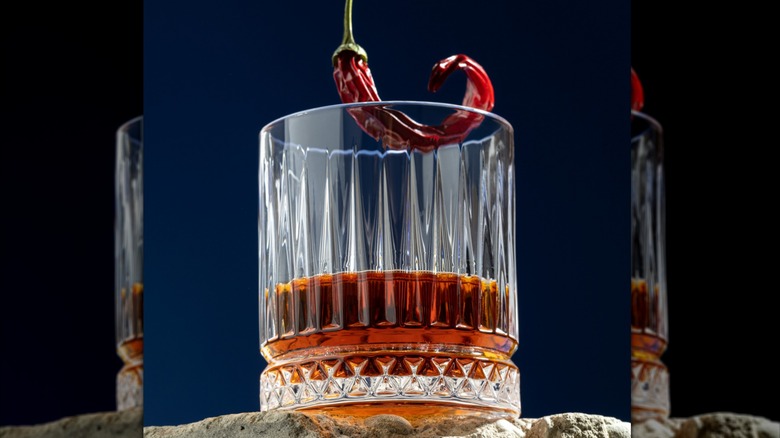 bourbon in glass with pepper