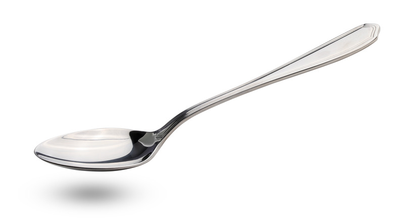 Silver spoon on white background