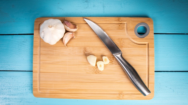 Cutting board, stainless steel knife, and garlic