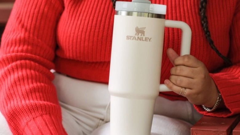 girl holding cream Stanley Quencher