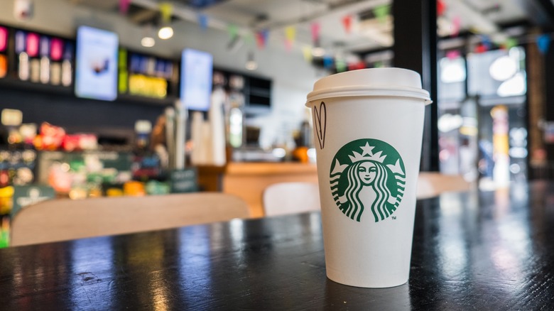 Starbucks coffee cup on table in cafe