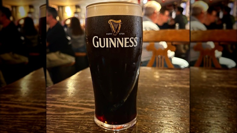 A pint of Guinness beer on a bartop