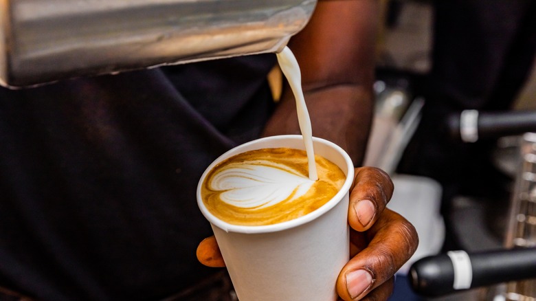 barista pouring to go latte 