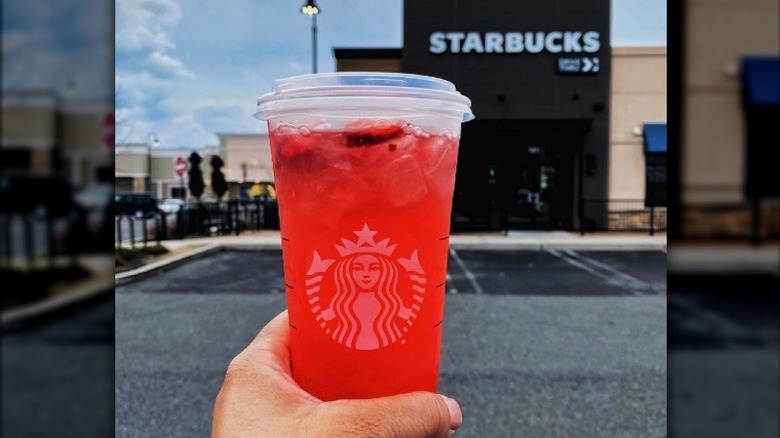 Hand holding a Strawberry Açaí Refresher 