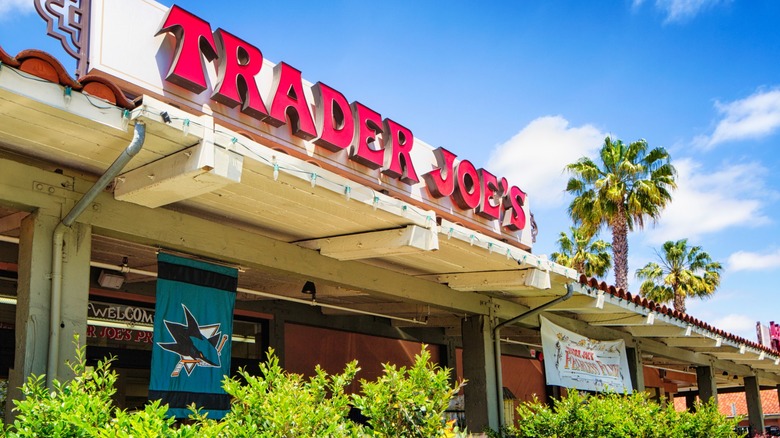 A California Trader Joe's store front with palm trees and blue sky
