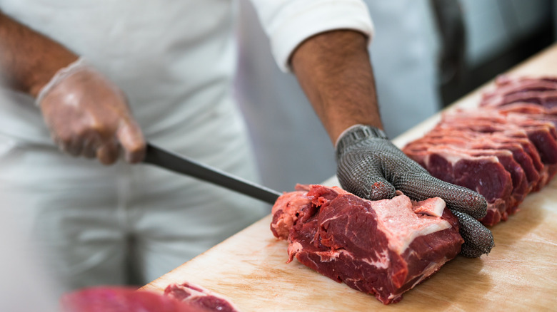 butcher cutting steak