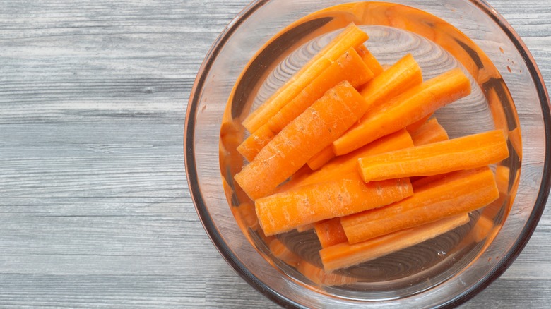Carrot slices submerged in water