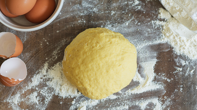 Ball of dough, flour, and eggs