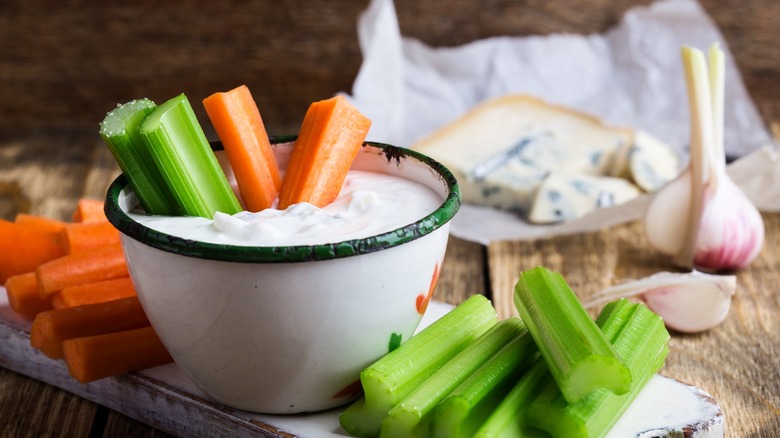 bleu cheese in a dipping bowl with celery and carrots