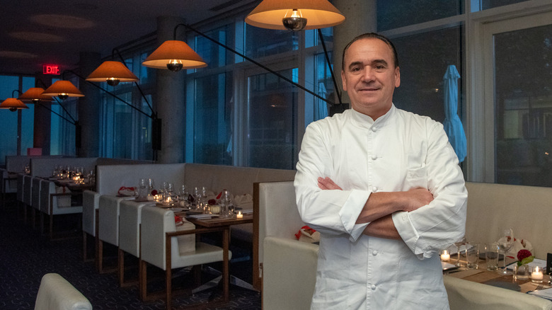 Chef Jean-Georges Vongerichten standing in a restaurant with arms folded