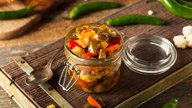 Jar of giardiniera on cutting board