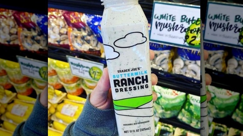 person holding Trader Joe's buttermilk ranch dressing