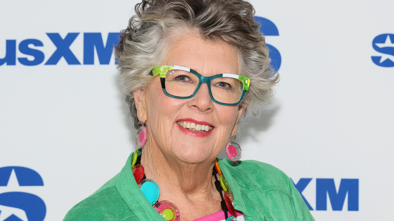 Prue Leith in green and white glasses with pink earrings