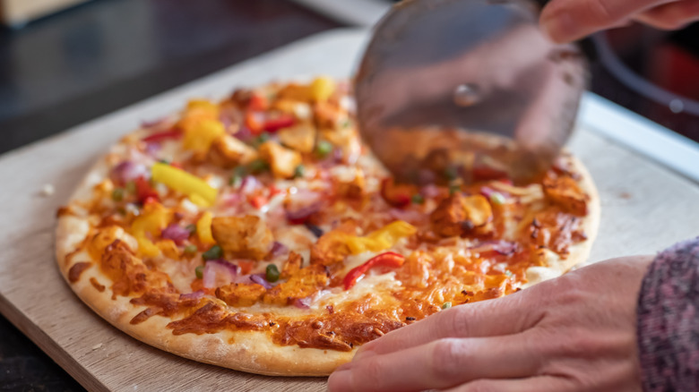 Cutting a cooked frozen pizza