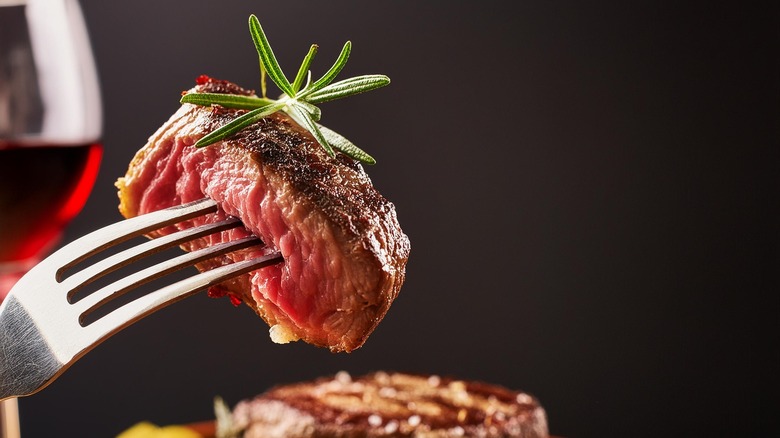 Bite of beef steak with rosemary