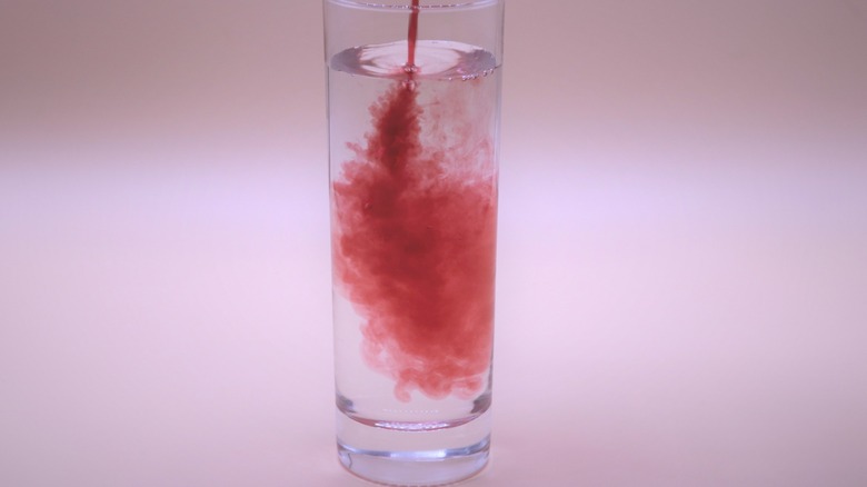 red dye in water glass