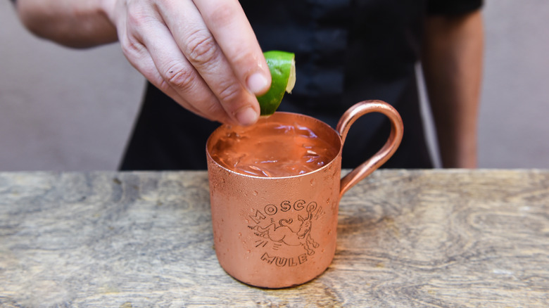 squeezing lime into Moscow Mule