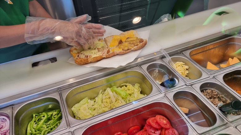 Subway worker preparing a sandwich