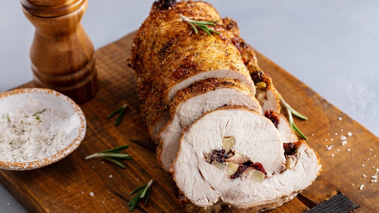 Stuffed pork loin on cutting board