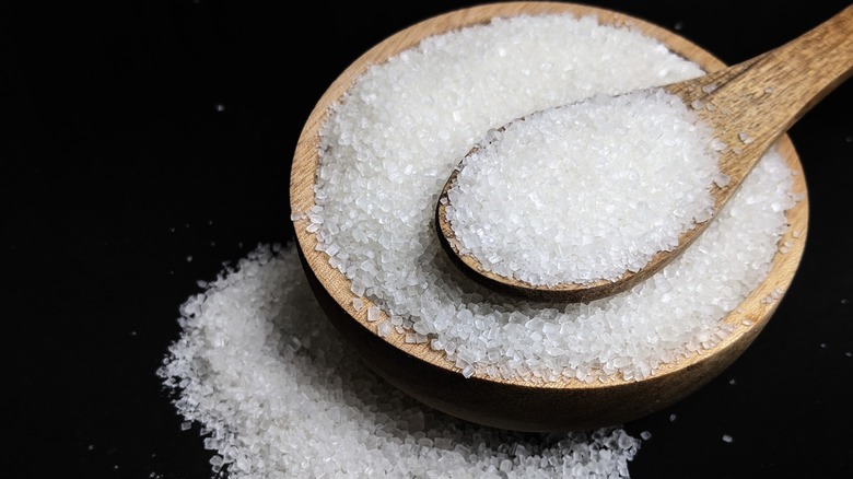 A bowl of granulated sugar with a spoon