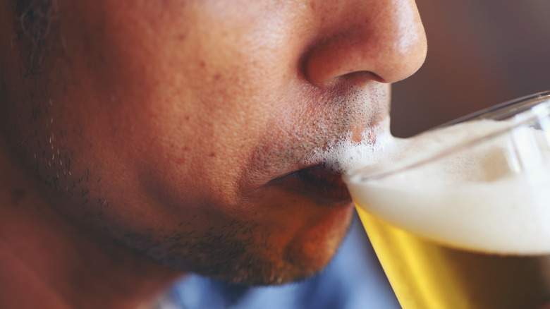 Close up of man drinking beer